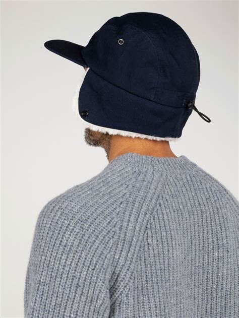 Sherpa Lined Earflap Cap In Navy Berings Finisterre Sherpa Lined