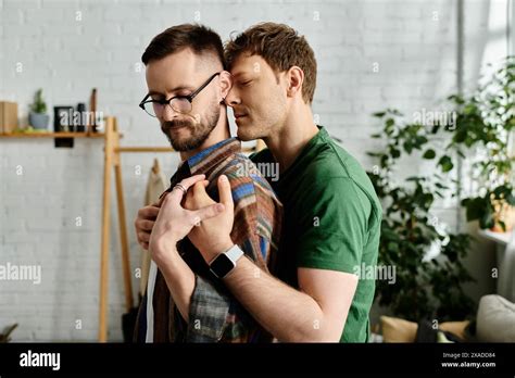Two Men A Gay Couple Stand Side By Side In A Designer Workshop Creating Trendy Attire For A