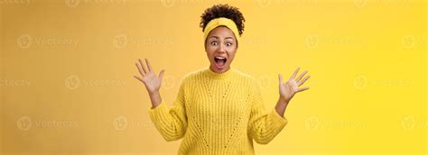 Excited happy stylish african woman in sweater yelling thrilled
