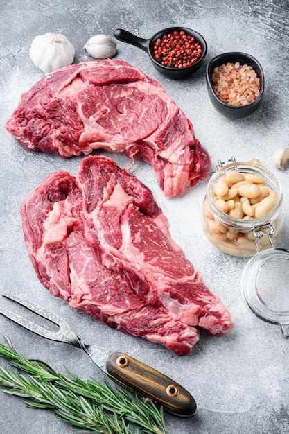 Premium Photo Raw Rib Eye Beef Marbled Meat Steak With Pepper And