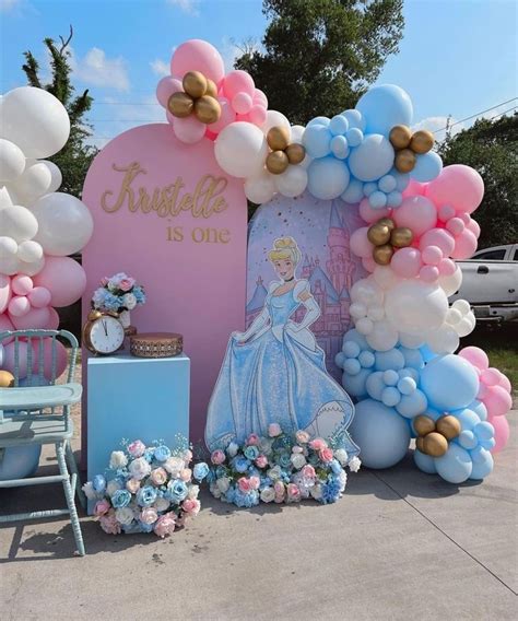 There Is A Balloon Arch That Has Princess Balloons On It And Flowers In