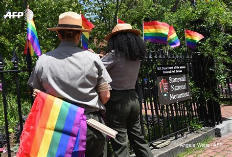 Park Rangers Place Rainbow Flags At The Stonewall National Monument