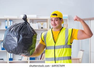 Man Cleaning Office Holding Garbage Bag Stock Photo 649357699