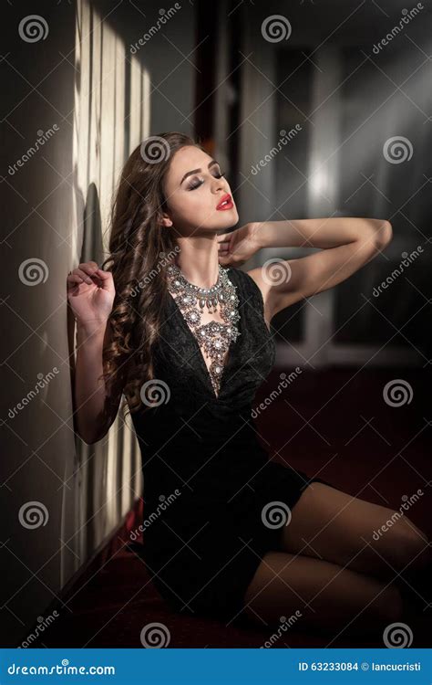 Young Beautiful Brunette Woman In Elegant Black Dress Playing On Piano