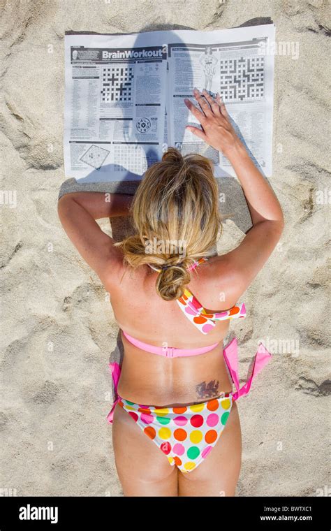 Sunbather On Amadores Beach In Gran Canaria Reading The Newspaper