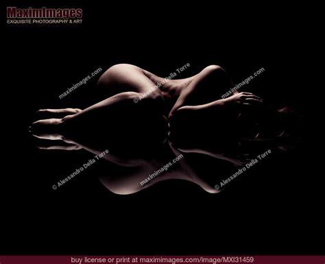 Abstract Art Nude Figure Of A Woman Lying Curled Up With A Reflection Stock Photo MXI31459
