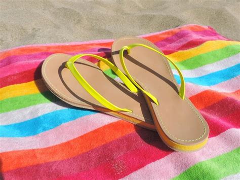 Premium Photo High Angle View Of Flip Flops On Beach Towel