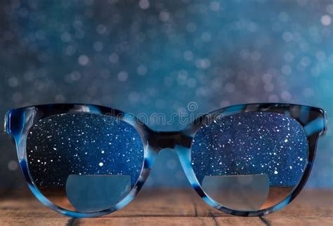 Eyeglasses Glasses With Bifocals And Black Blue Frame Smudged View Agaist A Starry Night Sky