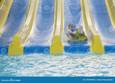 Beautiful Girl Riding A Water Slide Happy Woman Going Down On The