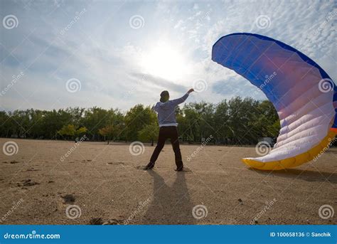 Man Tries To Catch The Wind With A Paraglider Stock Photo Image Of