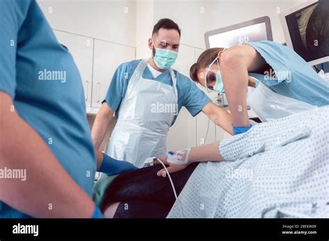 Proctologist In Surgery Of Hospital Performing Colonoscopy Stock Photo