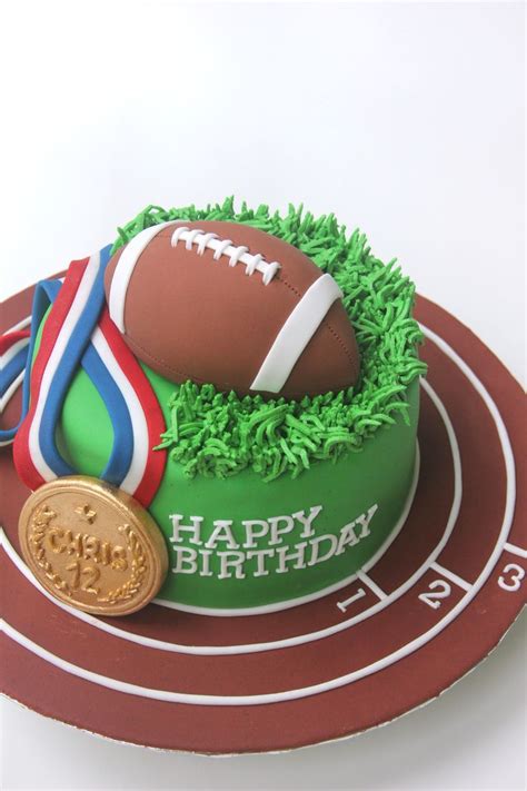 Sports-themed cake with American Football and Gold Medal toppers, and ...