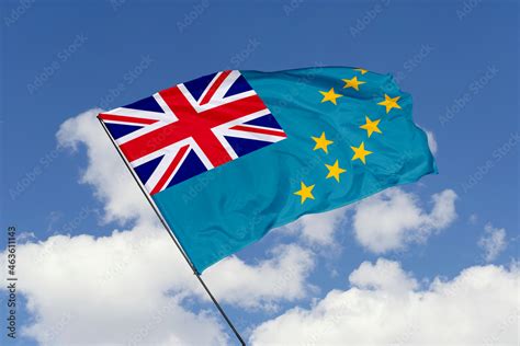 Tuvalu flag isolated on the blue sky background. close up waving flag ...