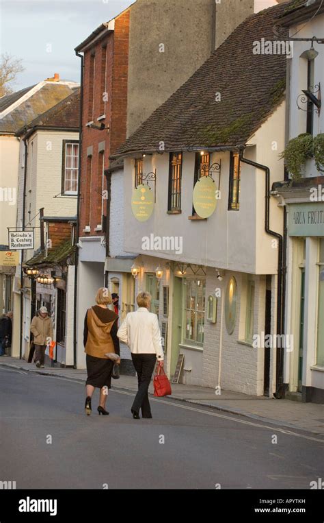 Two Shoppers Walking Amongst The Popular Shops And Cafes Of Arundel In West Sussex Uk Picture