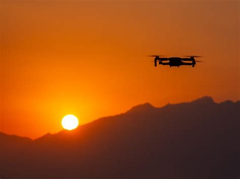 Silhouette of Flying Drone at Sunset · Free Stock Photo