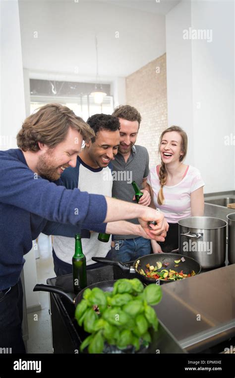 Happy Friends Cooking Together Stock Photo Alamy