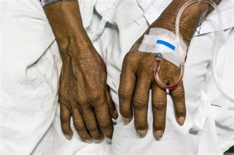 Premium Photo Cropped Hands Of Patient With Iv Drip On Bed In Hospital