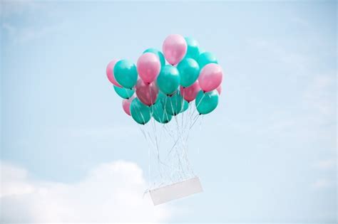 Premium Photo | Balloons with helium up in the sky with a blank board