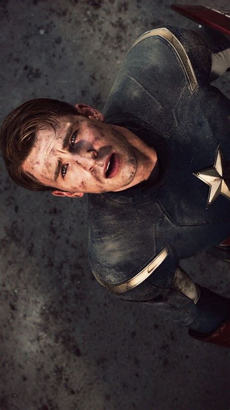 A Man Dressed As Captain America Standing In Front Of A Motorcycle With