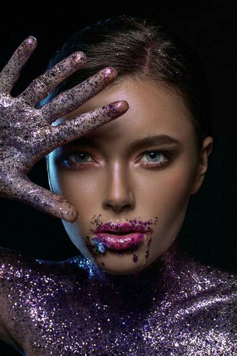 A Woman With Her Hands On Her Face And Body Covered In Purple Glitter