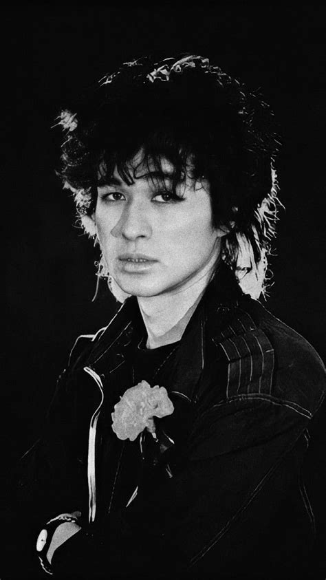 a black and white photo of a person wearing a jacket