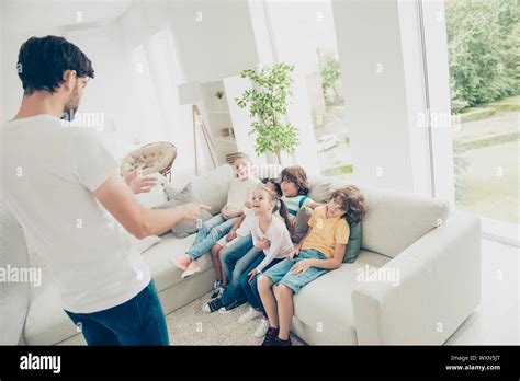 Curious Children Look At The Father Who Tells Stories Gesticulat Stock