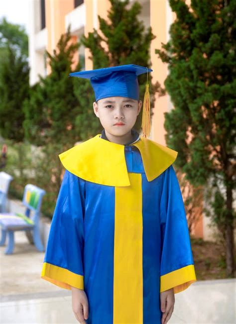 Boy Wearing Academic Dress and Graduation Cap · Free Stock Photo