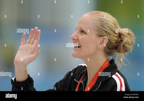 Kirsty Coventry Of Zimbabwe Waves On The Podium After Winning The Women