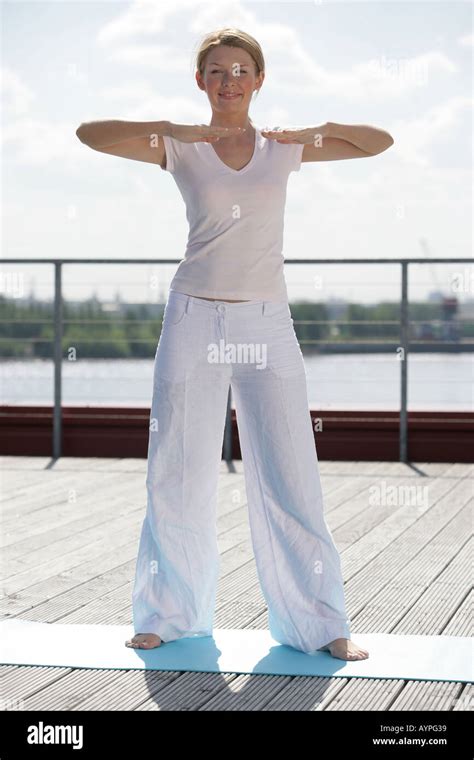 A Blonde Woman Exercising As She Smiles At The Camera Stock Photo Alamy