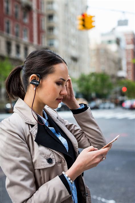 Busy Businesswoman Making A Call While Walking In The City By Stocksy