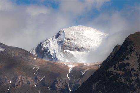 Premium Photo | Snowy mountain with clouds in the sky