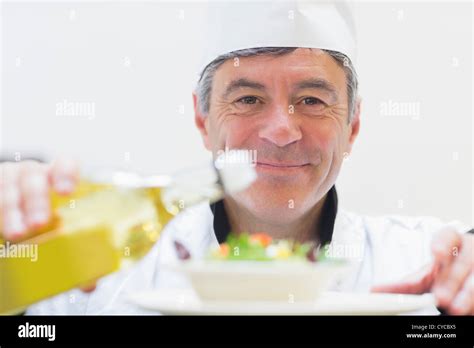 Chef dressing a salad Stock Photo - Alamy