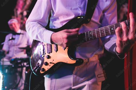 Concert View Of An Electric Guitar Player With Vocalist And Rock Band