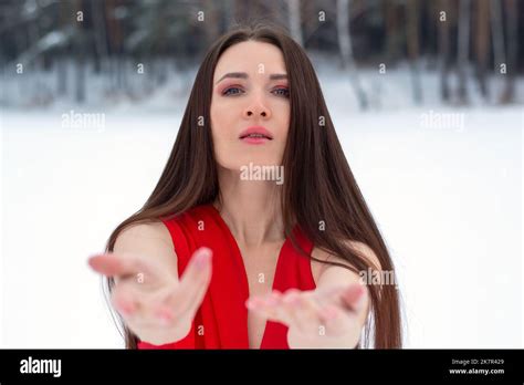 Beautiful Brunette Girl In A Thin Red Dress And Barefoot In The Winter Forest Stock Photo Alamy
