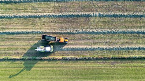 Premium Photo Aerial Of Tractor Baler Making Straw Bales In Field