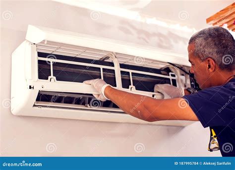 Man Worker Fixing Air Conditioning On The Wall Stock Photo Image Of