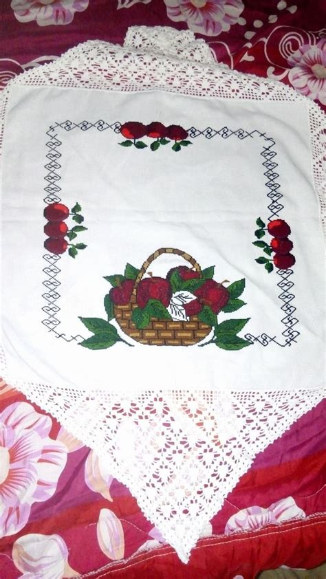 A Table Cloth With A Basket And Flowers On It