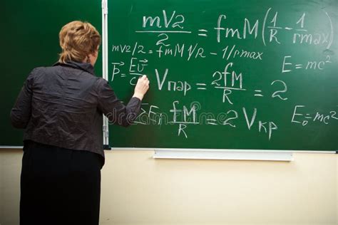 Math Teacher Writing Formula On The Blackboard Stock Photo - Image ...