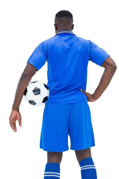 Premium Photo Football Player In Blue Holding Ball