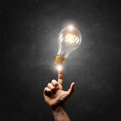 Hand Pointing Light Bulb Stock Photo Image Of Glass 70589758