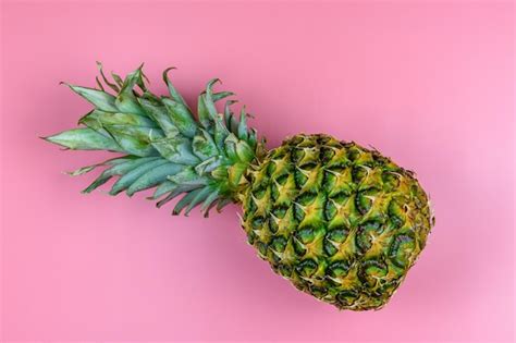 Premium Photo Whole Ripe Pineapple On The Pink Background