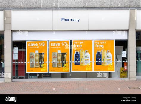 Window display of a typical high street Boots Pharmacy branch featuring posters promoting ...