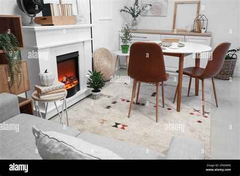 Interior of modern dining room with fireplace Stock Photo - Alamy