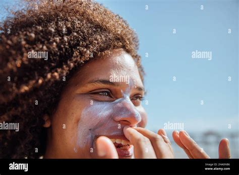 Woman Applying Sunscreen On The Beach Stock Photo Alamy