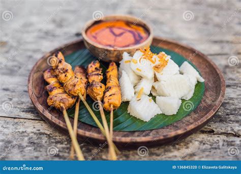 Indonesian Chicken Satay Or Sate Ayam Served With Lontong Soy Sauce