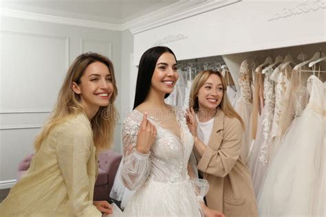 Bride with Friends Choosing Wedding Dress in Boutique Stock Photo ...