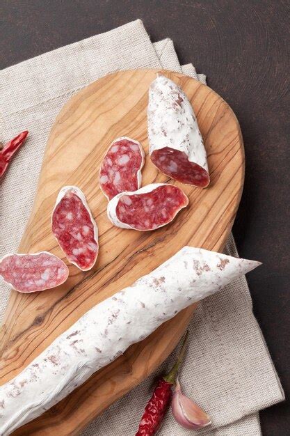 Premium Photo Sliced Salami On Cutting Board Top View