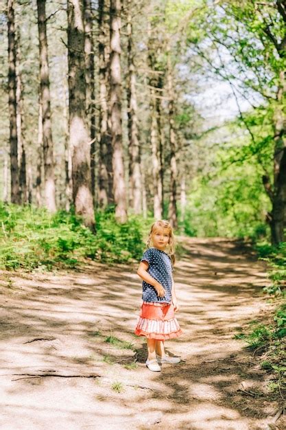 Premium Photo Girl Standing Against Trees In Forest