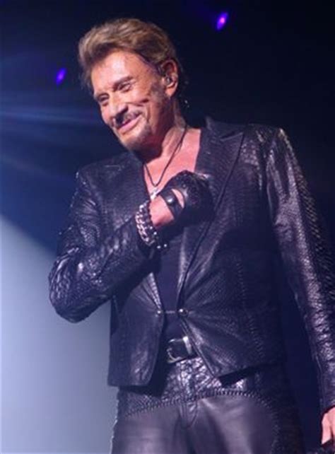 A Man In Black Leather Jacket Standing On Stage