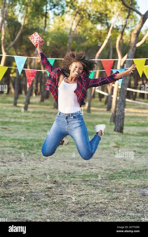 Happy And Excited Woman Jumping And Smiling While Celebrating Her